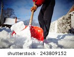 Man with snow shovel cleans sidewalks in winter. Winter time. Latvia. Europe. 