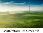 Wonderful foggy green field at sunrise, view from above, Europe
