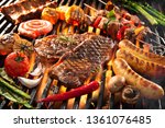 Assorted delicious grilled meat with vegetables sizzling over the coals on barbecue