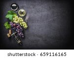 Wineglasses with grapes and corks on dark background with copy space
