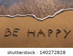 be happy, words written on the beach