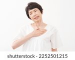Small photo of Asian senior woman having a palpitation of the heart in white background