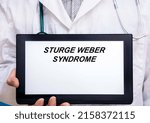 Small photo of Sturge Weber Syndrome. Doctor with rare or orphan disease text on tablet screen Sturge Weber Syndrome