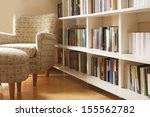 Home library with arm chair. Clean and modern decoration.