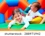 happy kids having fun on playground in kindergarten