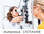 Small photo of Optometrist giving Slit lamp examination of the eyes in ophthalmology clinic