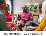 Small photo of Midsection of multiracial senior males and females discussing during group therapy session. unaltered, support, alternative therapy, community outreach, mental wellbeing and social gathering.