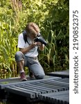 Small photo of Dedemsvaart, Netherlands- August 16, 2022: Photographer at work in the gardens of Mien Ruys, Netherlands