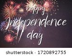 Holiday night sky with fireworks and hand lettering text Happy Independence Day