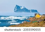 Small photo of Panoramic view of colorful Kulusuk village in East Greenland - Kulusuk, Greenland - Melting of a iceberg and pouring water into the sea