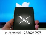 Small photo of Lviv Ukraine - 23 07 23: mobile phone with new logo X for twitter on blue background with white bird, Elon Musk vows to ditch bird logo, closeup