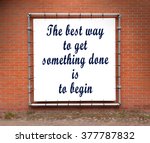 Small photo of Large banner with inspirational quote on a brick wall - The best way to get something done is to begin