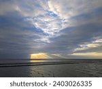 Small photo of Tranquil Scene at Heysham Beach with Dramatic Sky and Crepuscular Rays