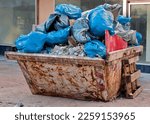 Small photo of Containers with garbage bags, rubble and bulky waste