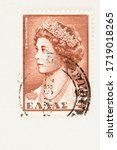 Small photo of SEATTLE WASHINGTON - April 29, 2020: Close up of 1957 Greek postage stamp with portrait of Queen Frederica with copy space. Scott # 614