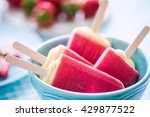 sorbet popsicles in bowl, fresh fruits in background