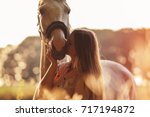 Woman kissing her horse at...