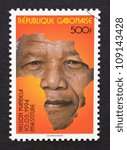 Small photo of Gabonese Republic - CIRCA 1994: postage stamp printed in Gabonese Republic showing an image of Nelson Mandela with the african continent, circa 1994.