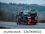 Small photo of Car transportation by big rig semi truck allows all dealerships to ensure uninterrupted sale of new and used cars ensuring consumer demand in any state of America. Trucks carry out the main freight