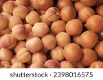 Small photo of Fruits apricots, peaches, natural background, blur, selective focus. Color of the year 2024, peach fuzz color