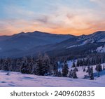 Small photo of Picturesque winter alps sunrise. Highest ridge of the Ukrainian Carpathians is Chornohora with peaks of Hoverla and Petros mountains. View from Svydovets ridge and Dragobrat ski resort.
