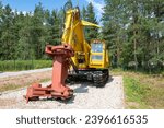 Small photo of SHARYA, RUSSIA - AUGUST 07, 2022: Feller buncher machine on a caterpillar chassis on a sunny summer day. Forest Museum