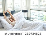 Woman Stretching In Bed After...