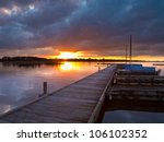 Boats along a jetty during a tranquil sunset