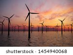 Offshore Wind Turbines Farm At sunset