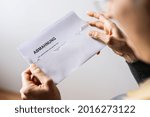 Small photo of Abmahnung, Sehr geehrte dame, sehr geehrter Herr (German for: final notice, Dear Madam, dear Sir) Hand Holding Receiving an open a Final Notice Envelope concept of lawyer or business