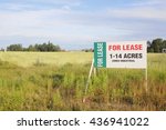 Small photo of A sign advertises land acreages for lease/Leased Industrial Land/A sign advertises land acreages for lease.