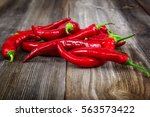 Red hot peppers on wooden background.