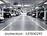 Underground parking with cars. White colors.