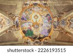 Small photo of VARALLO, ITALY - JULY 17, 2022: The baroque ceiling fresco of Eucharistic adoration of angels in the church Collegiata di San Gaudenzio by Carlo Bartolomeo Borsetti (1702).