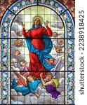 Small photo of DOMODOSSOLA, ITALY - JULY 19, 2022: The Assumption of Virgin Mary on the stained glass in church Chiesa dei Santi Gervasio e Protasio by Luigi Fontana from 19. cent.