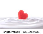 Plain yogurt with fresh heart shape watermelon on top isolated on white background