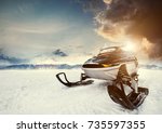 Small photo of Snowmachine on the mountain lake frozen surface with thunderstorm clouds on the background