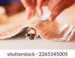 Small photo of An array of sushi is presented on a platter, ready to be enjoyed by a group of diners. The variety of flavors and textures make for a truly memorable meal