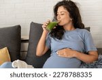Small photo of Beautiful pregnant woman drinking healthy green fruit and vegetable home made smoothie. Fresh colorful healthy fruit juice. Healthy lifestyle in pregnancy. Smoothies for woman expecting baby.