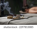 Small photo of Moxibustion treatment - traditional Chinese medicine tools for acupuncture points heating therapy. Chinese herbal medicine. Moxibustion copper burner box with moxa herbal sticks in holistic spa.