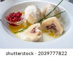 Traditional food on Swedish Baltic Sea island Öland. Kroppkaka is a traditional boiled potato dumpling filled with minced pork and onion and often served with cream and lingon berries.