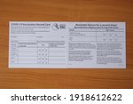 Small photo of Bangkok, Thailand - February 17 2021: COVID-19 Vaccination record card by CDC, Vaccination form during the coronavirus epidemic on table background