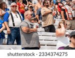 Small photo of July 17, 2023 - Loudon, NH, USA: Fans watch as drivers race for position for the Crayon 301 at the New Hampshire Motor Speedway in Loudon NH.