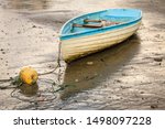 Old Rowboat On A Beach During...