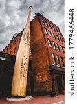 Small photo of Louisville, KY, February 23, 2020: Oversized baseball bat sculpture in front of Louisville Slugger museum and factory in downtown Louisville, Kentucky