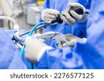 A team of doctor or surgeon did surgery inside operating room in hospital.People holding medical equipment or surgical tool in keyhole endoscopic surgery.Minimal invasive joint arthroscopic procedure.