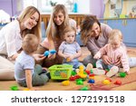 Small photo of Group of mothers with babies toddlers at playgroup