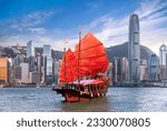 Small photo of Red vintage sailboat for tourist pass from Hong king city side to kowloon city, Hongkong icon for travel, China