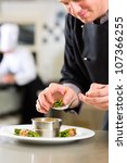 Small photo of Chef in hotel or restaurant kitchen cooking, he is working on the sauce for the food as saucier