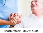 Nurse Holding Hand Of Senior...